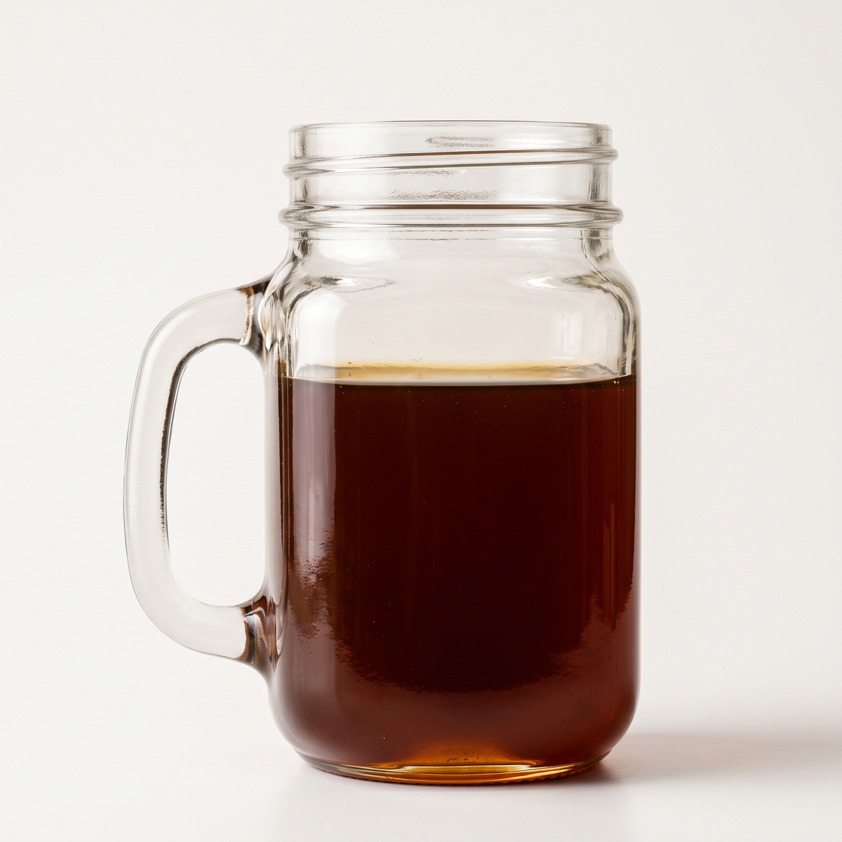 Jar of bold, dark amber Palo Santo honey against a plain background